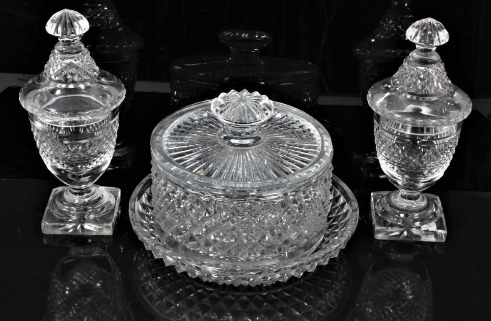 Georgian cut glass butter tub and lid on stand, together with a pair of cut glass urns and covers