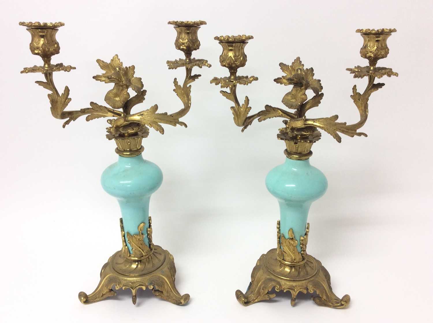 Pair of rococo ormolu and porcelain twin branch candelabra