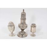 Georgian silver caster of baluster form with an associated cover, two other Victorian casters