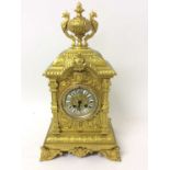 Impressive late 19th century gilt metal mantel clock with cast urn mount, human mask and floral scro