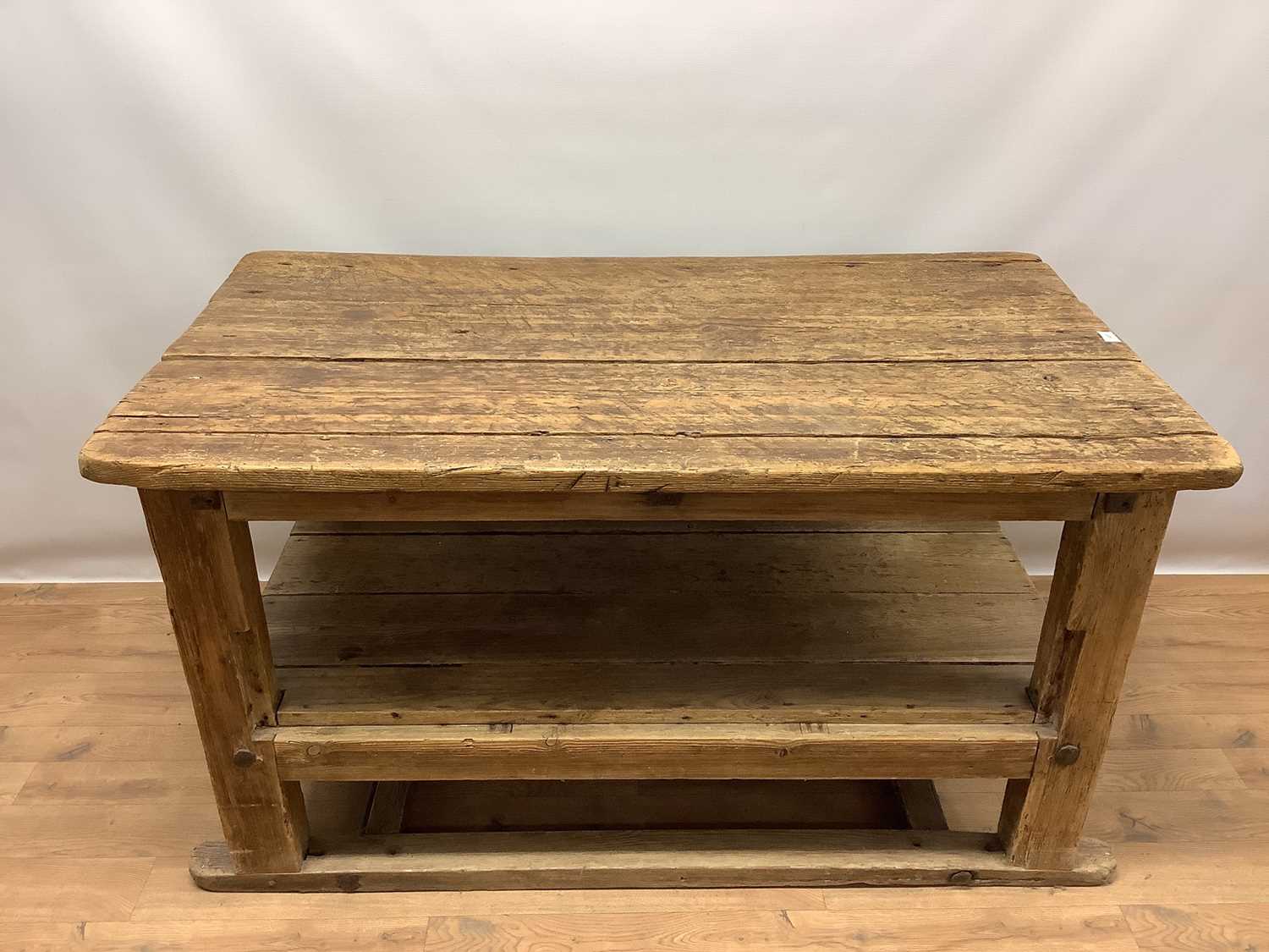 Rustic two tier pine kitchen table, with plank top and undertier raised on square supports, 133cm wi