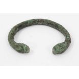 Ancient bronze bangle, probably Roman, with animal head terminals