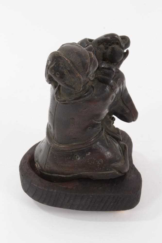 Chinese bronze figure of a man making a devotional offering, on a later wooden base - Image 3 of 13
