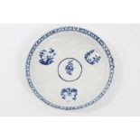 Lowestoft blue and white saucer, circa 1765, relief moulded, with circular panels containing Chinese