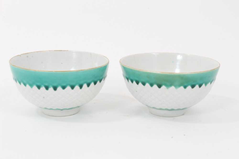 Pair of unusual Bow tea bowls, circa 1770, with pineapple moulding, turquoise borders, and flower at