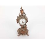 19th century French brass mantel clock, decorated in the rococo style with a cherub, scrollwork moti