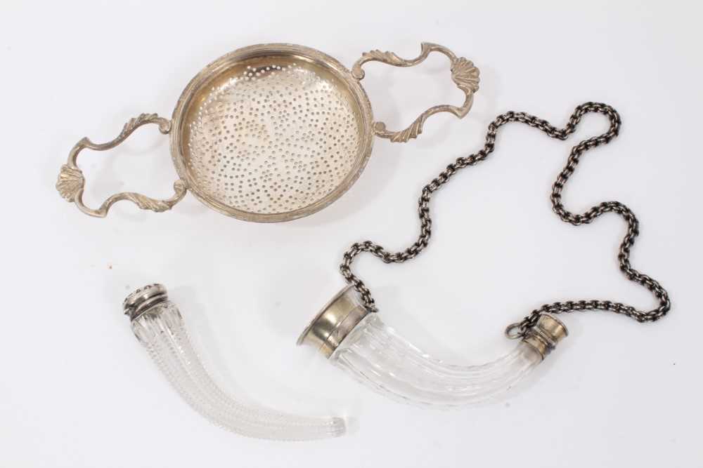 Silver tea strainer together with two silver mounted glass scents