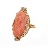 Carved coral cameo and diamond ring with an oval relief carved coral cameo depicting a classical fem