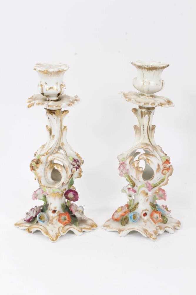 Pair of Paris flower-encrusted candlesticks, circa 1860, with gilt scrollwork stems, 25cm tall
