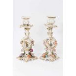 Pair of Paris flower-encrusted candlesticks, circa 1860, with gilt scrollwork stems, 25cm tall