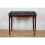 George III style mahogany silver table, of serpentine outline with pierced gallery on square tapered