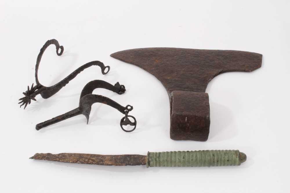Two early iron spurs, together with a bronze handled knife and an iron axe head