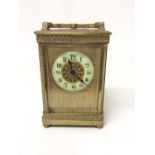 Edwardian brass carriage clock with enamelled dial 14.5 cm high, key present