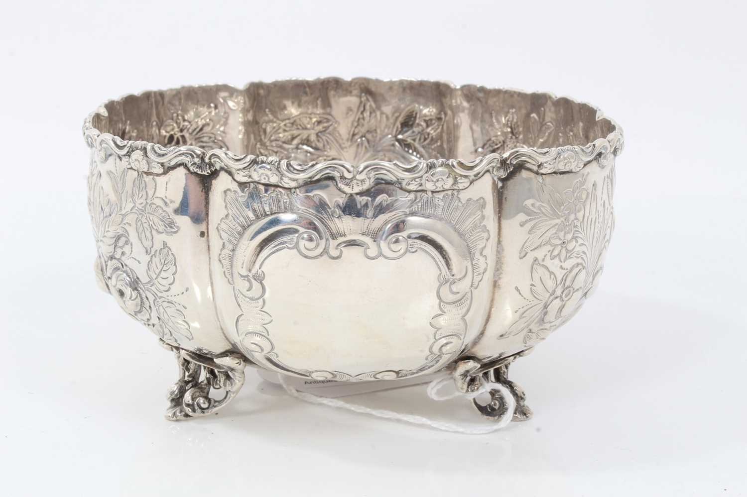 Victorian silver sugar bowl with embossed foliate panels, on scroll feet