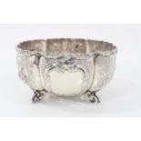 Victorian silver sugar bowl with embossed foliate panels, on scroll feet