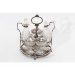 George III silver cruet stand with five matching bottles
