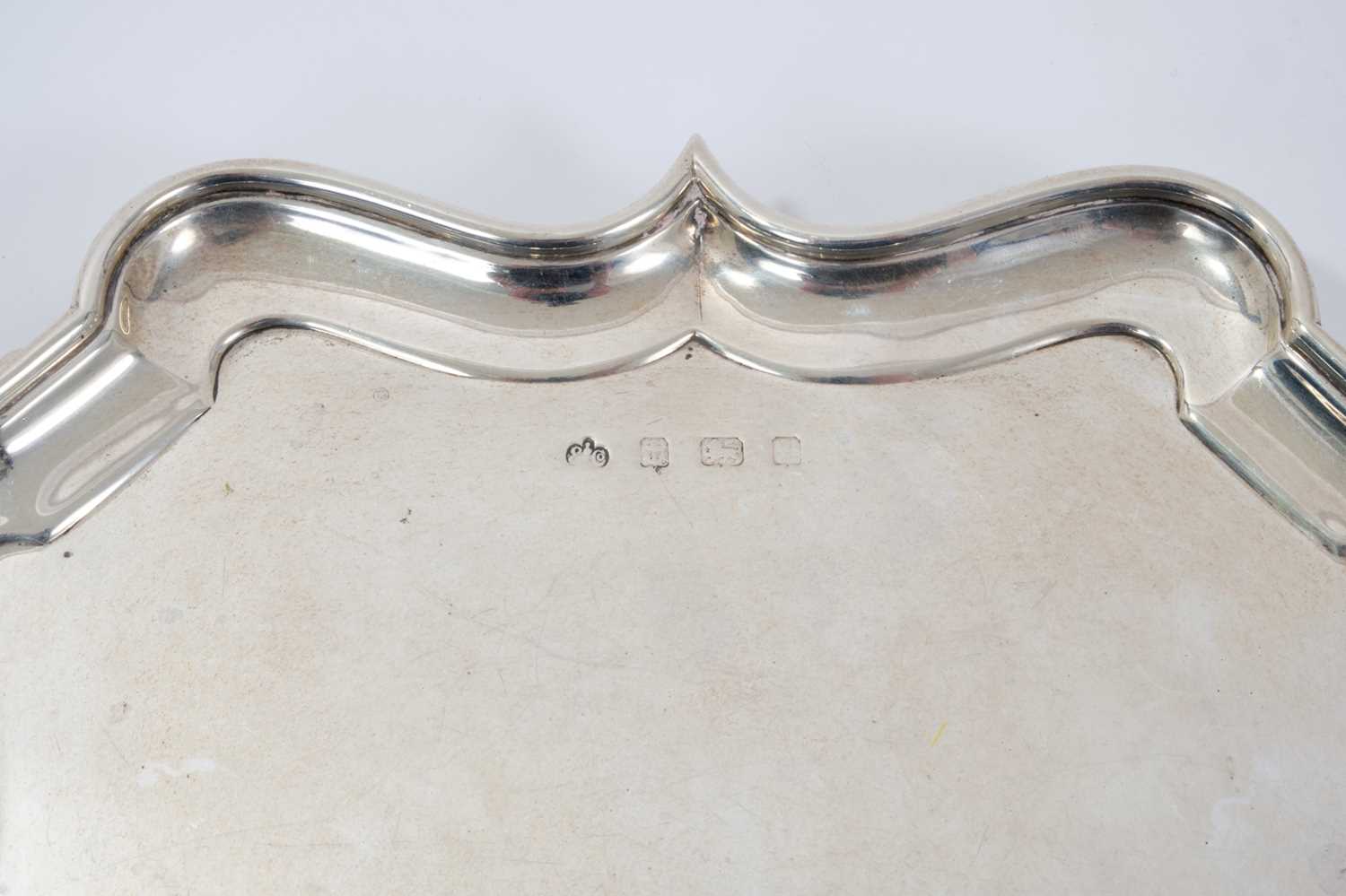 Early George V silver salver of shaped square form, with piecrust border, on four hoof feet - Image 2 of 3