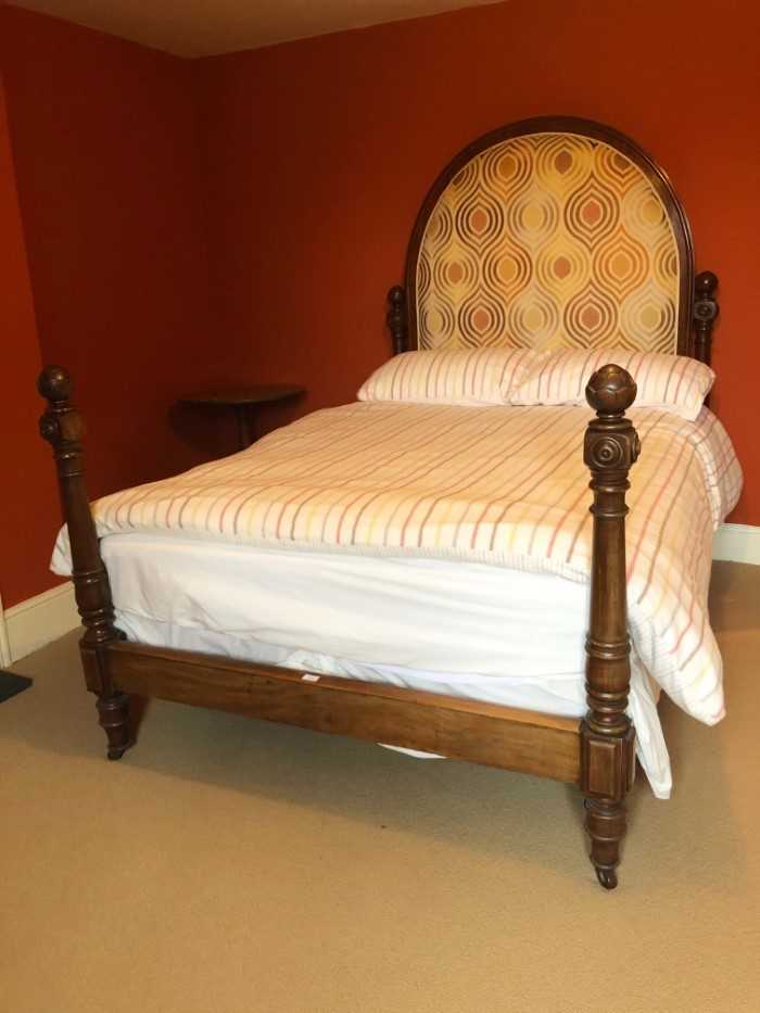 Victorian mahogany framed double bedstead, the upholstered arched headboard flanked by carved and tu