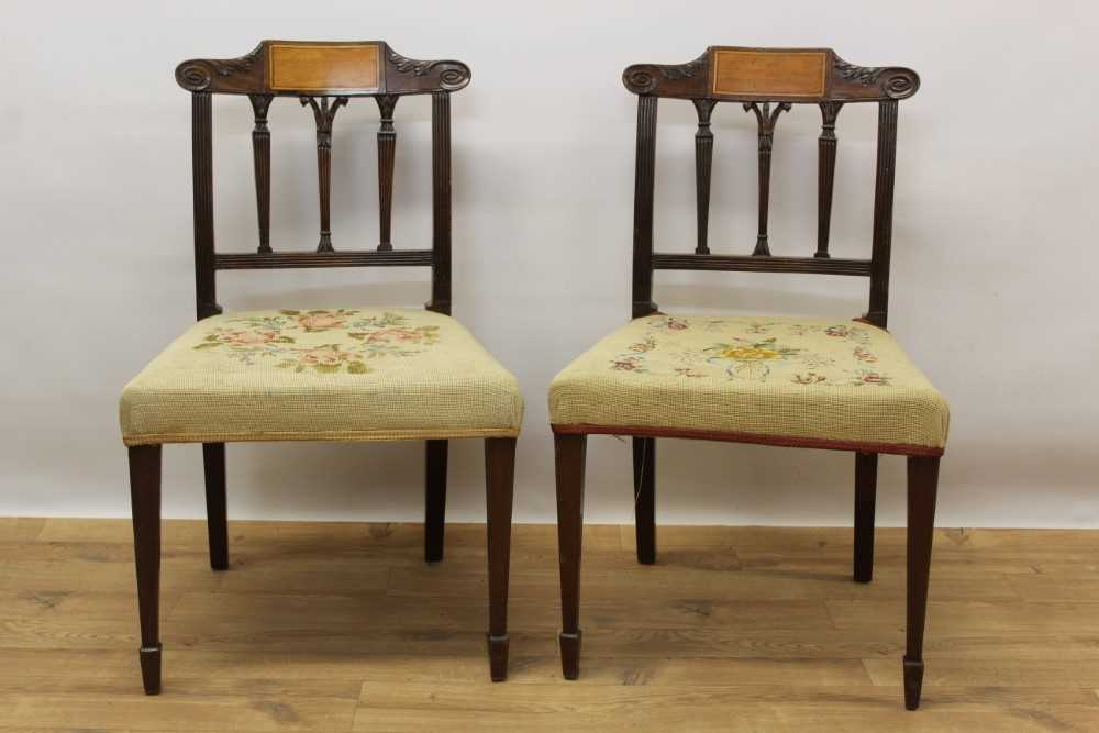 Pair of late 18th century Sheraton inlaid mahogany dining chairs, with shaped scroll top rail above