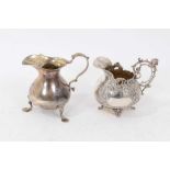 Victorian silver cream jug of baluster form, with scroll handle, on three paw feet