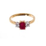 Ruby and diamond three stone ring with rectangular step cut cut ruby flanked by two brilliant cut di