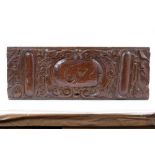 17th century carved oak plaque, dated 1674, 39cm long