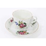 Worcester faceted coffee cup and saucer, circa 1770, polychrome painted with flowers