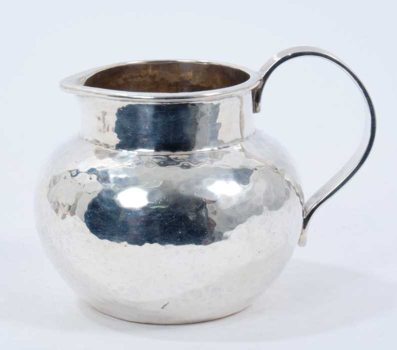 1920s silver cream jug of baluster form, with spot hammered finish