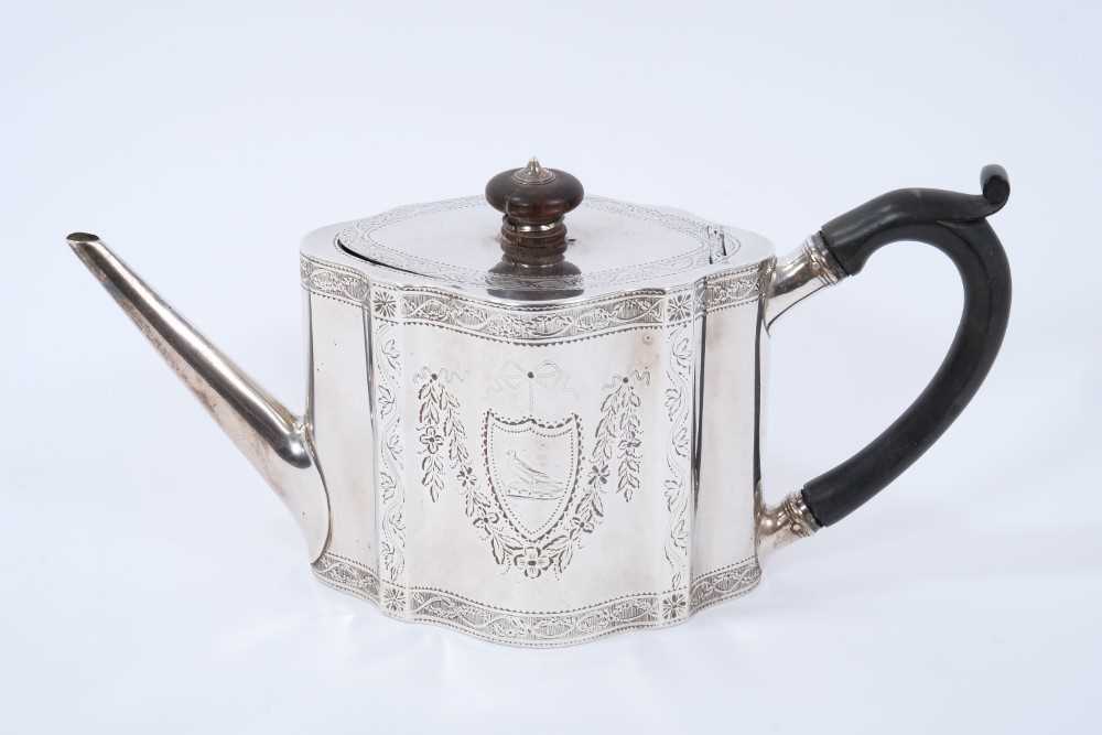 George III silver teapot of shaped form, with engraved foliate decoration