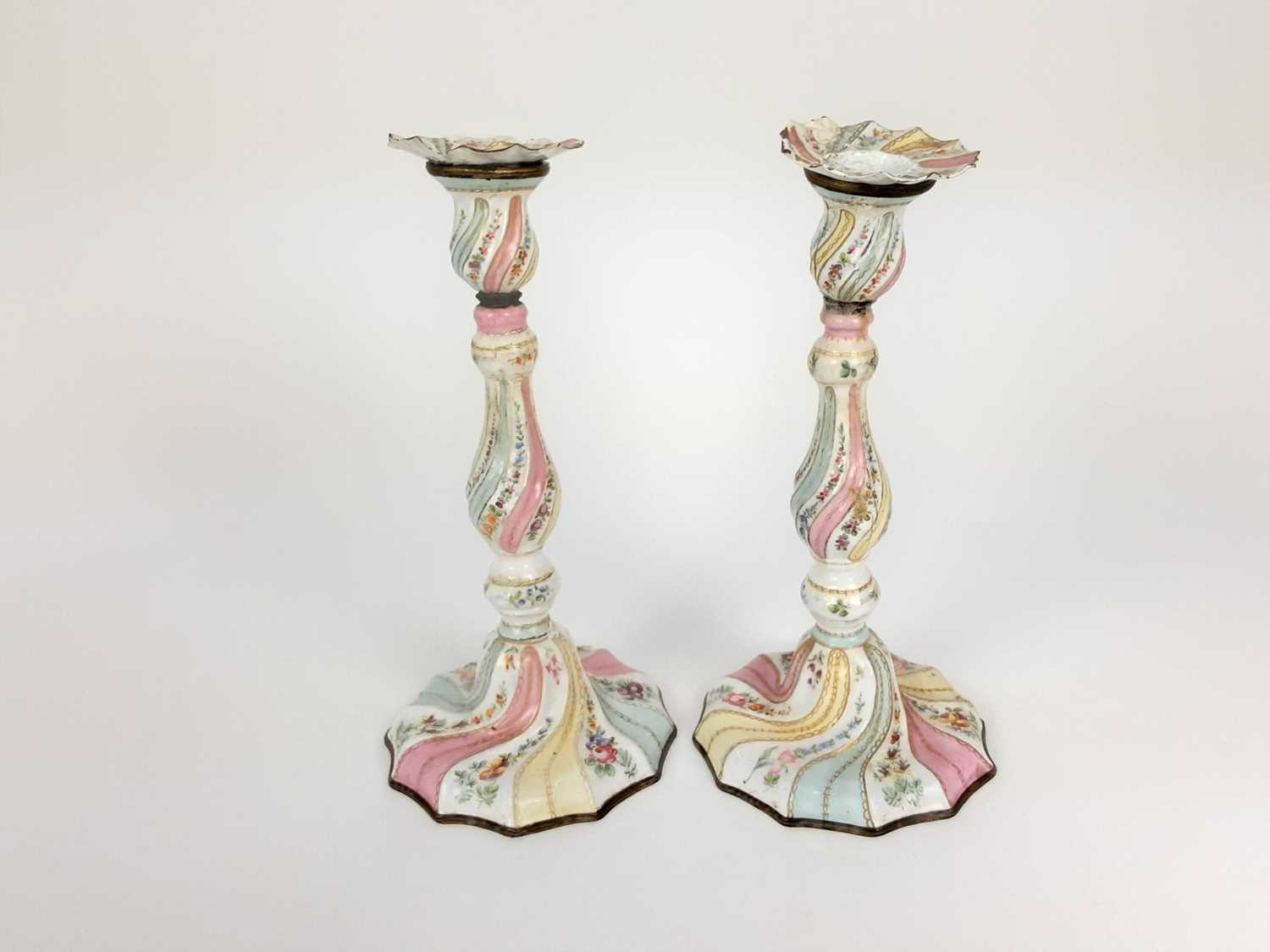 Pair of 18th century enamelled candlesticks, possibly Bilston, with spiralling knopped stems, painte