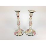 Pair of 18th century enamelled candlesticks, possibly Bilston, with spiralling knopped stems, painte