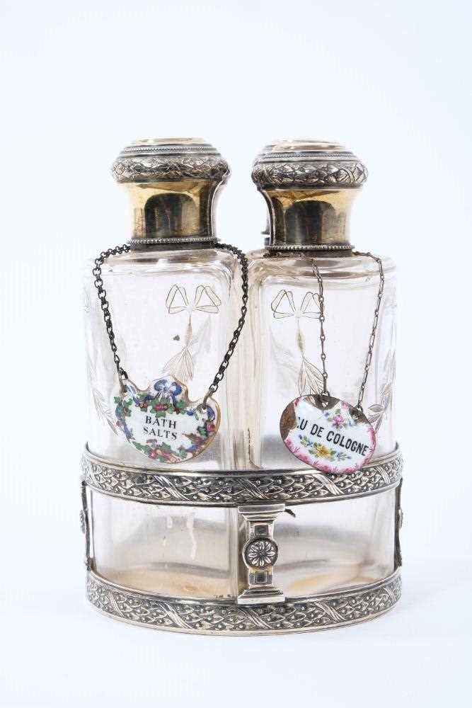 Set of four early 20th century French silver and glass toiletry bottles, with gilded decoration, eac