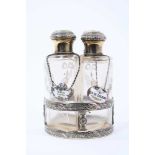 Set of four early 20th century French silver and glass toiletry bottles, with gilded decoration, eac