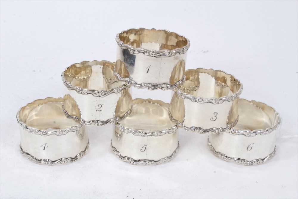 Set of six Edwardian silver napkin rings, with scroll borders and engraved 1- 6,