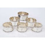 Set of six Edwardian silver napkin rings, with scroll borders and engraved 1- 6,