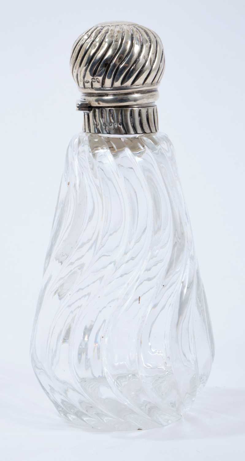 Victorian wrythen pattern cut glass toilet bottle of conical form with silver hinged cover