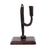 18th century wrought iron nip rush light holder, the arm with candlestick socket, fruitwood base,