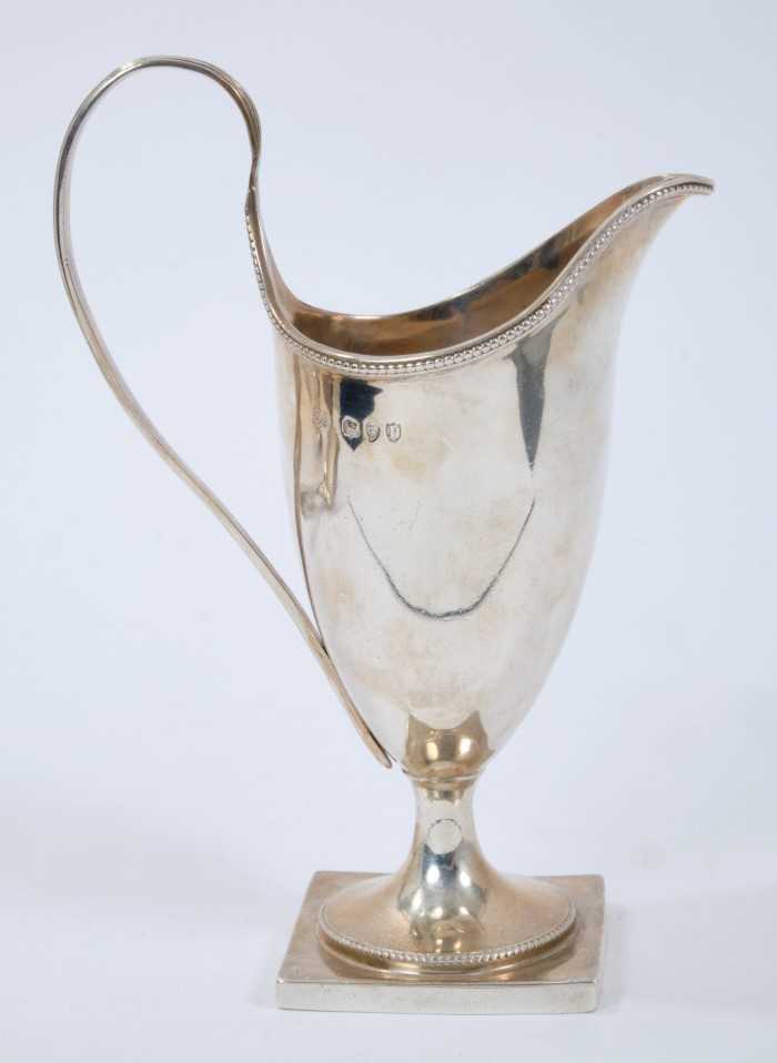 Victorian silver helmut cream jug, with reeded loop handle, on a square base