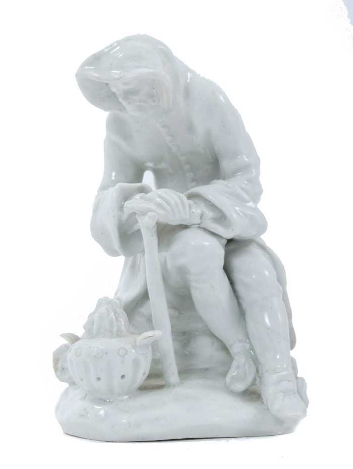 Bow blanc de chine figure, circa 1755, in the form of a seated elderly man warming his hands on a br