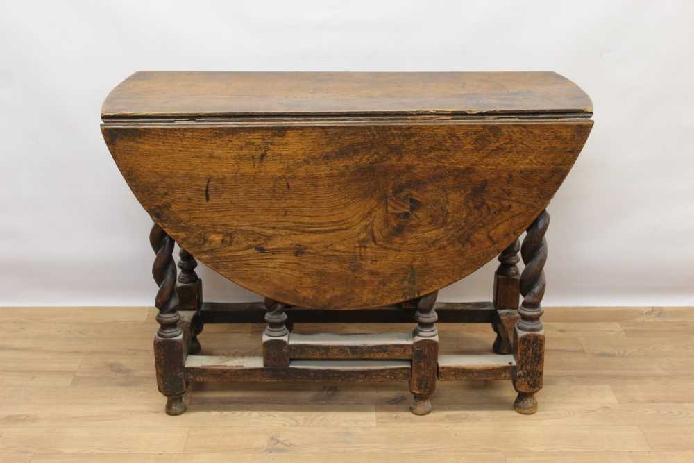 17th century style oak drop leaf table, elliptical hinged top on barley twist and block understructu