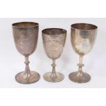 Three silver trophy cups of conventional form, with engraved floral decoration and inscriptions