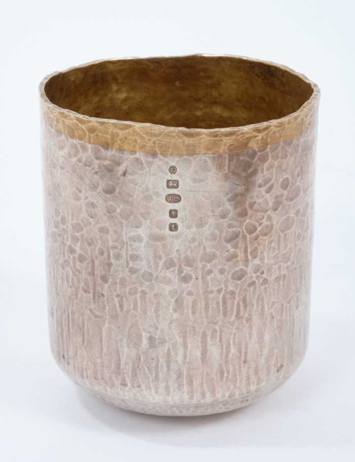 Contemporary silver tumbler cup with spot hammered finish and silver gilt interior and external rim