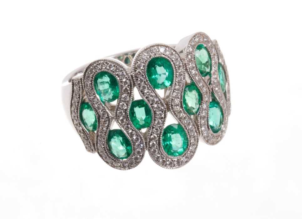 Emerald and diamond dress ring with ten oval mixed cut emeralds within brilliant cut diamonds, all i
