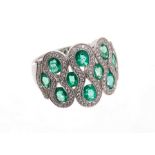 Emerald and diamond dress ring with ten oval mixed cut emeralds within brilliant cut diamonds, all i