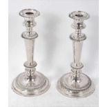 Pair of Old Sheffield plate candlesticks with stepped sloped gadroon borders