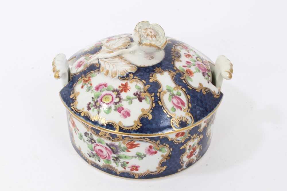 Worcester butter tub and cover, circa 1770, painted with flowers in gilt scrollwork panels, on a blu