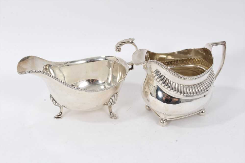 Silver sauceboat together with a cream jug