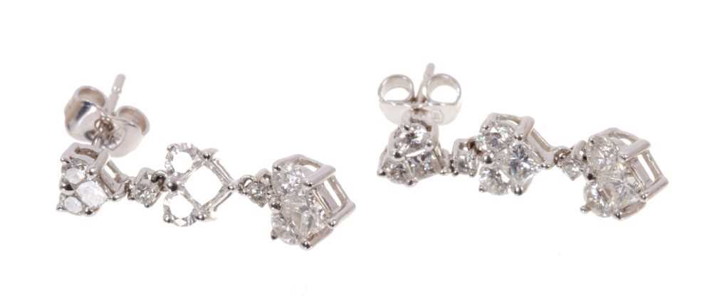 Pair of diamond pendant earrings with heart shape clusters