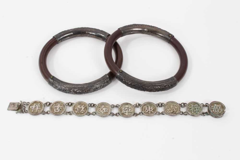 Two 19th century Chinese carved bamboo and silver mounted bangles and a Chinese silver bracelet