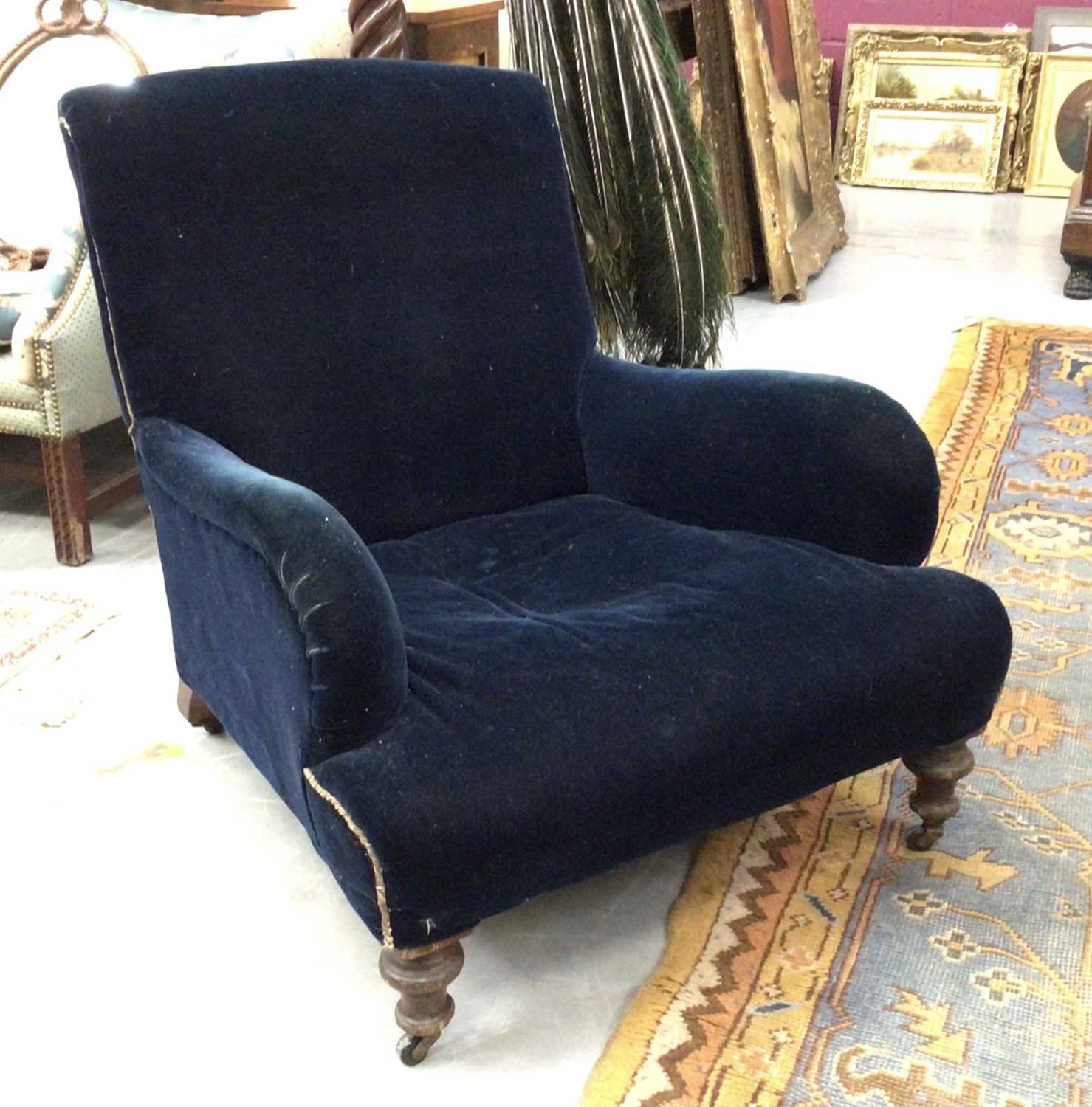 Late 19th / early 20th century oak upholstered deep armchair in the manner of Howard & Sons